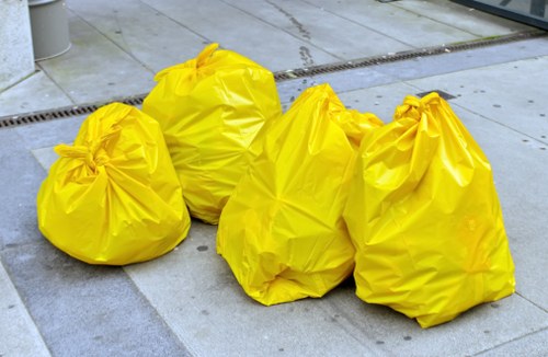 Van being loaded with commercial rubbish outside a shop in Carshalton